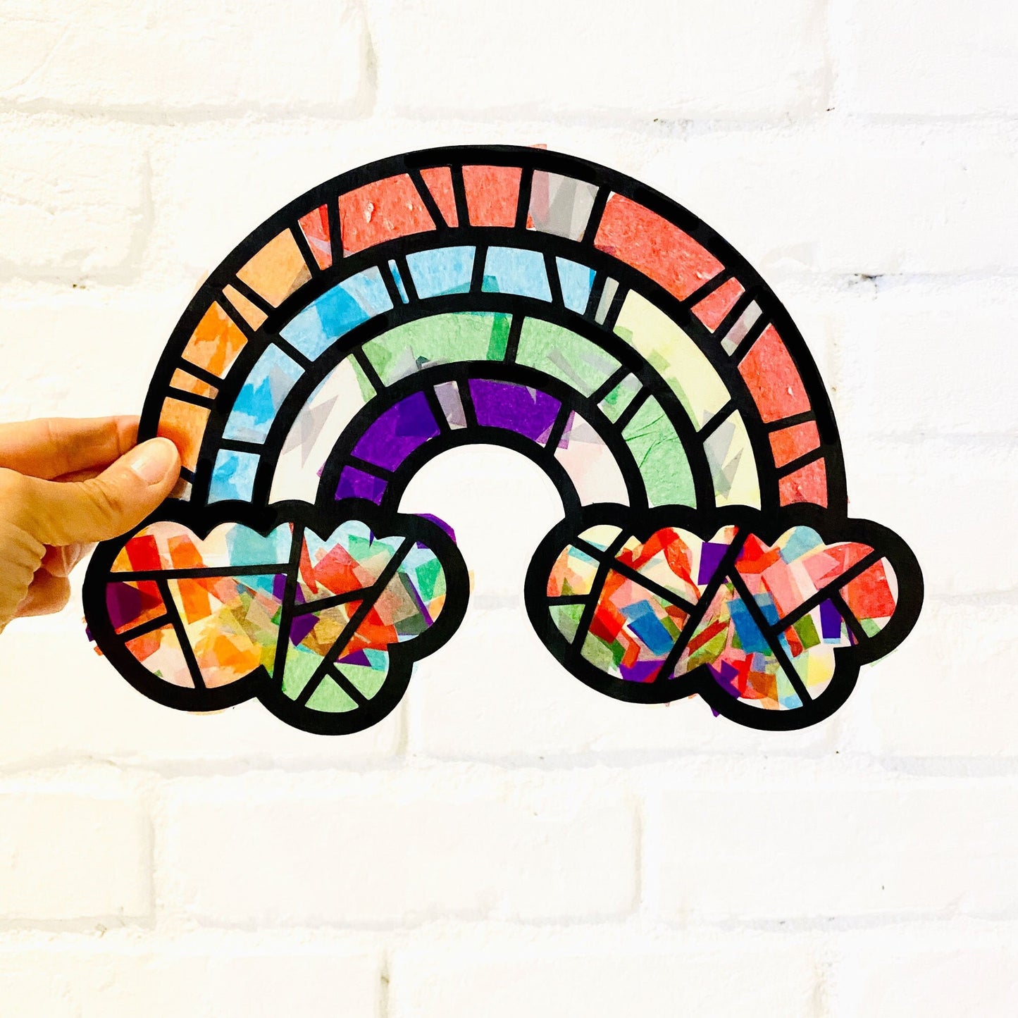 Large rainbow craft kit for kids. Make a simple paper stained glass piece of art at your Rainbow birthday party for toddlers.