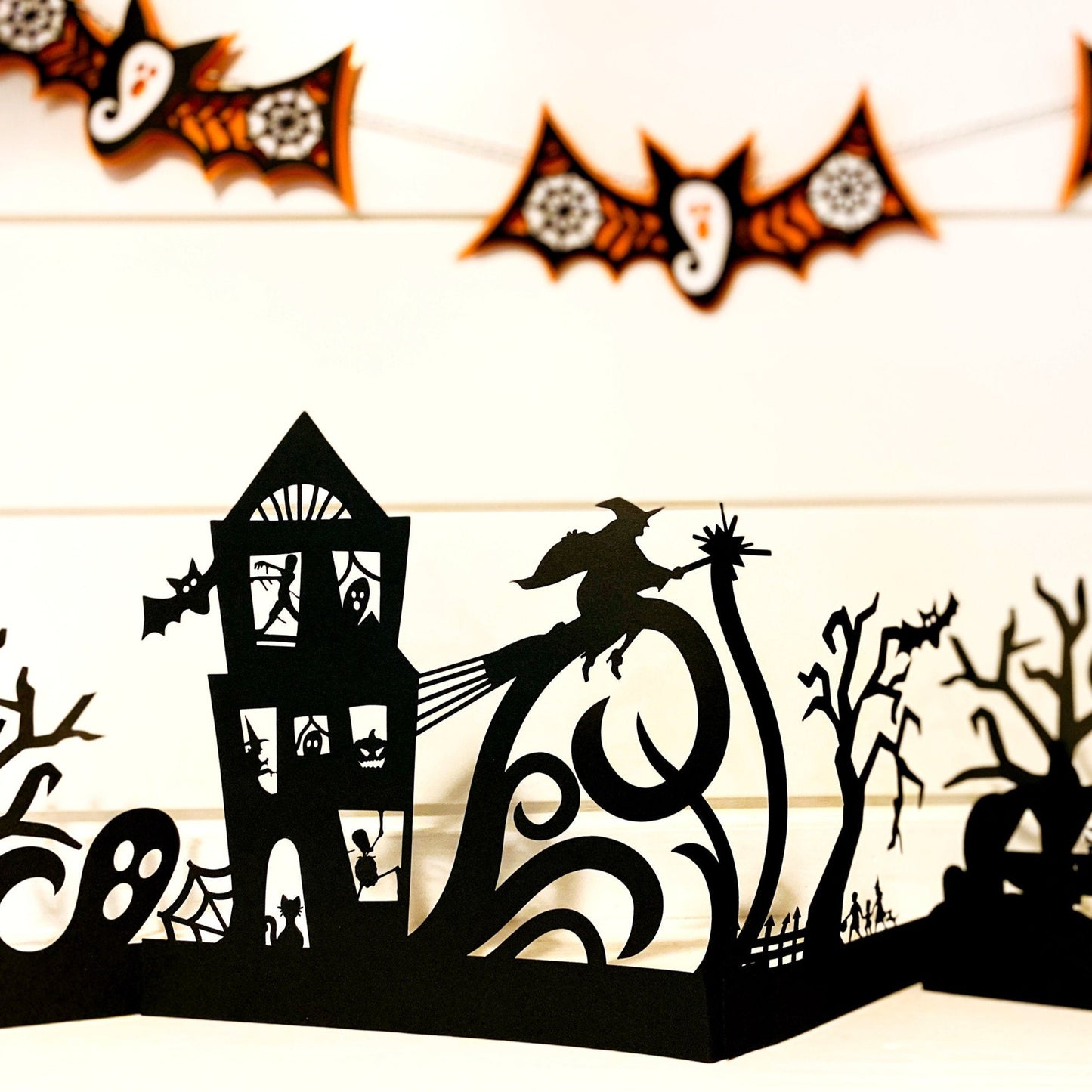 Spooky village paper Halloween display. Minimal haunted house accordion house for Halloween mantel.